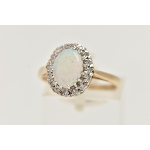 12 - A 9CT GOLD OPAL AND DIAMOND CLUSTER RING, of an oval form, set with an oval cut white opal cabochon,... 