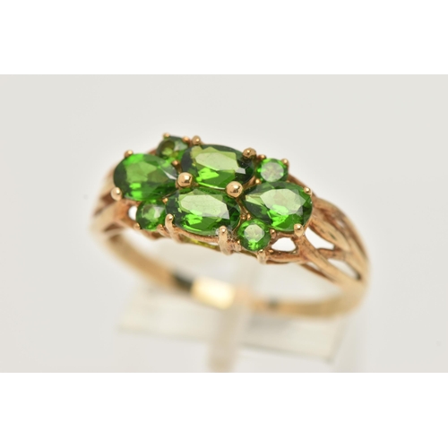 51 - A 9CT GOLD GEM SET RING, dress ring set with four oval cut and four circular cut green garnets, each... 