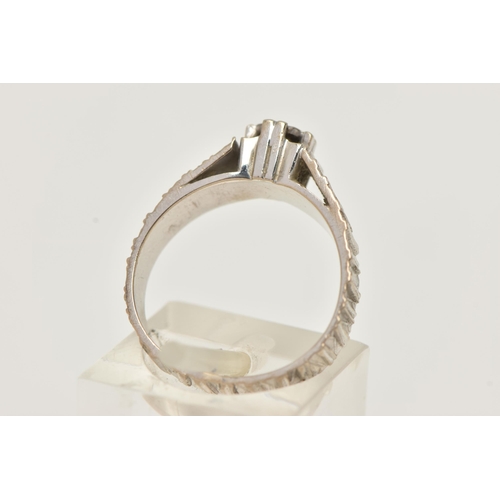83 - A DIAMOND RING, designed as a central brilliant cut diamond in an illusion setting with tapered text... 