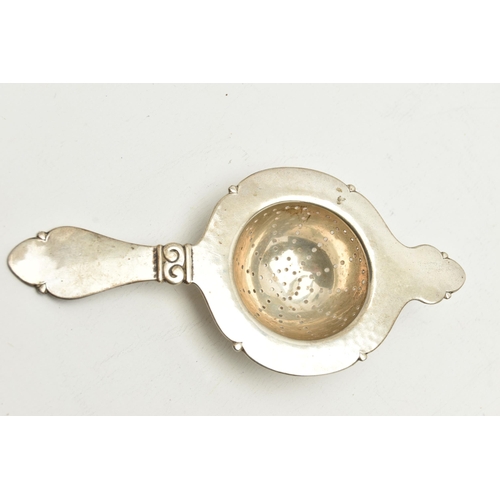 138 - A WHITE METAL TEA STRAINER WITH STAND, stamped with Danish silver control marks for Christian F Heis... 