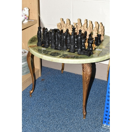 313 - A CIRCULAR CHESS TABLE AND TWO SETS OF CHESS PIECES, comprising a faux marble chess table, diameter ... 