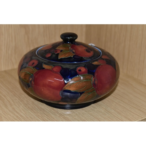 318 - A MOORCROFT POTTERY 'POMEGRANATE' PATTERN COVERED JAR, comprising a deep purple and red pomegranate ... 