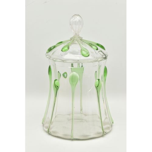 55A - AN EARLY 20TH CENTURY CLEAR AND GREEN GLASS JAR AND COVER, the cover with reeded finial and ladle sl... 