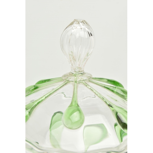 55A - AN EARLY 20TH CENTURY CLEAR AND GREEN GLASS JAR AND COVER, the cover with reeded finial and ladle sl... 
