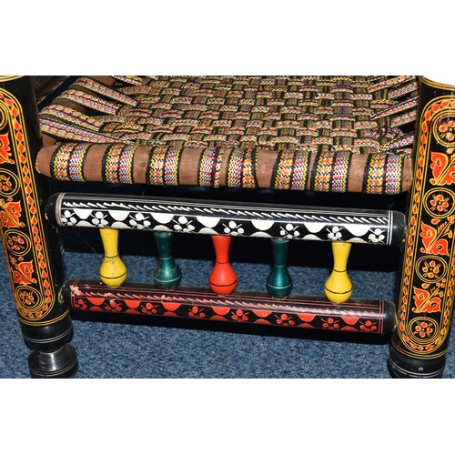 85A - A PAIR OF 20TH CENTURY PAKISTANI CHARPAI CHAIRS, brightly painted decoration and woven fabric seats,... 