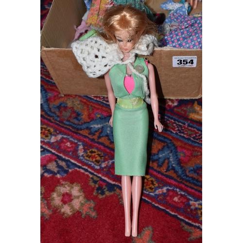 354 - A QUANTITY OF EARLY 1970S DOLLS AND CLOTHING, to include Mattel Heather from Rock Flowers, Topper Da... 