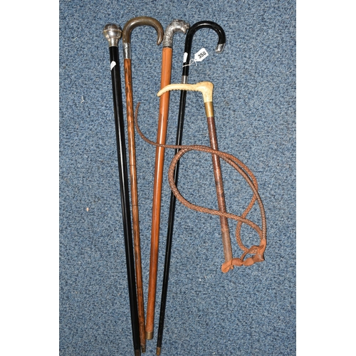 358 - A GROUP OF FOUR WALKING STICKS AND A HUNT MASTER'S RIDING CROP, comprising a Moss Bros. plaited leat... 