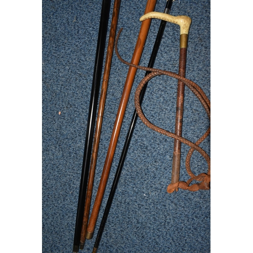 358 - A GROUP OF FOUR WALKING STICKS AND A HUNT MASTER'S RIDING CROP, comprising a Moss Bros. plaited leat... 