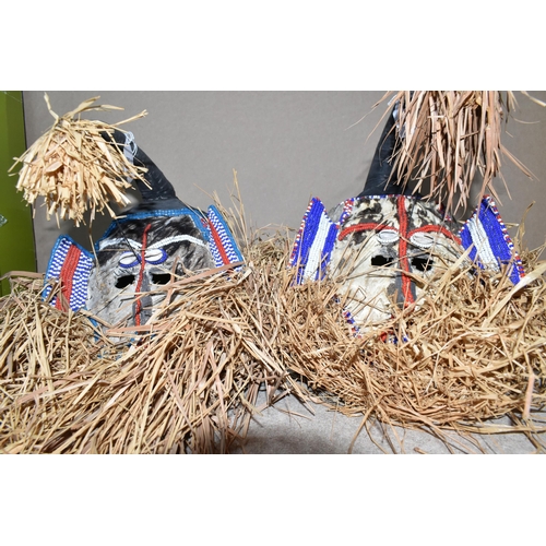 422 - A PAIR OF KUBA MASKS to include two elephantine stylised traditional masks embellished with cowrie s... 