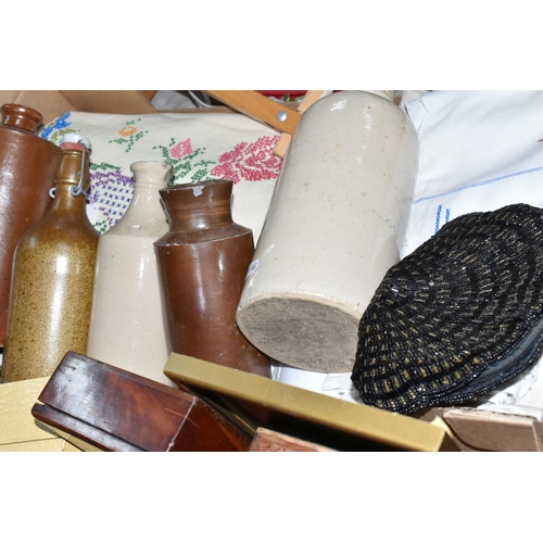 584 - TWO BOXES OF TREEN, STONEWARE AND TABLE LINEN, to include two stoneware foot warmers, a collection o... 