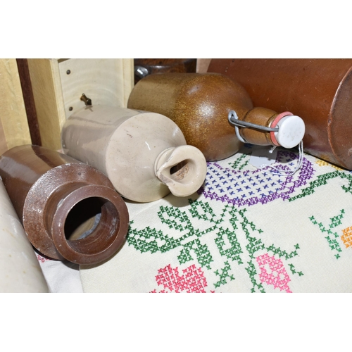 584 - TWO BOXES OF TREEN, STONEWARE AND TABLE LINEN, to include two stoneware foot warmers, a collection o... 