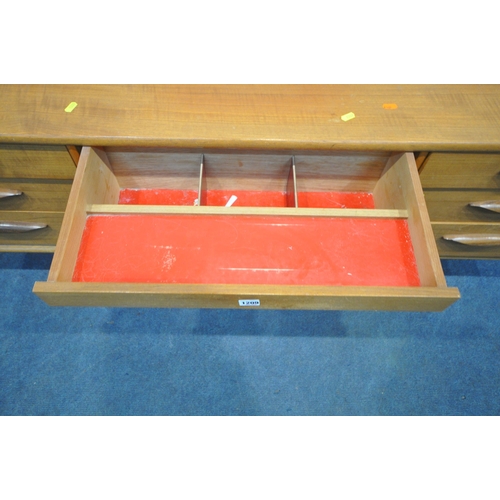 1209 - AN AUSTINSUITE MID CENTURY TEAK DRESSING TABLE, with a rectangular mirror, fitted with seven drawers... 