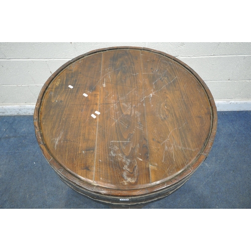 1222 - AN OAK AND METAL BANDED BARREL PUB TABLE, raised on three legs, united by stretchers, diameter appro... 