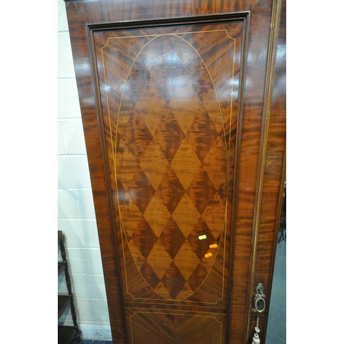 1238 - AN EDWARDIAN MAHOHANY COMPACTUM WARDROBE, the double doors flanking a central bevelled mirrored door... 