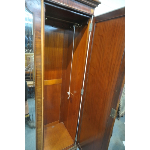 1238 - AN EDWARDIAN MAHOHANY COMPACTUM WARDROBE, the double doors flanking a central bevelled mirrored door... 