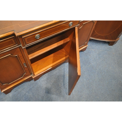 1240 - A REPRODUCTION MAHOGANY BREAKFRONT SIDEBOARD, fitted with three drawers above three cupboard doors, ... 