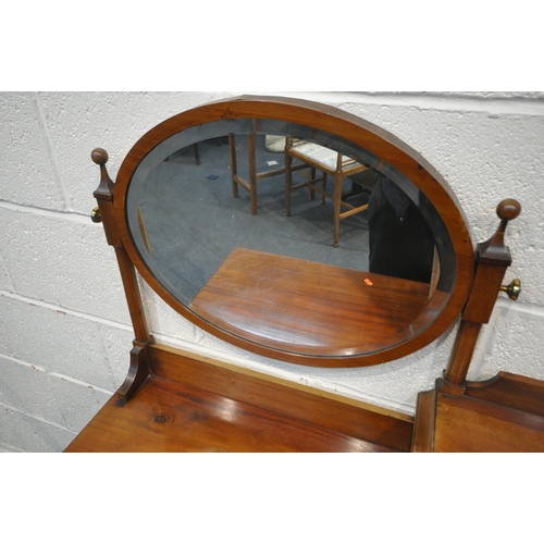 1244 - AN EARLY 20TH CENTURY MAHOGANY DRESSING TABLE, with an oval bevelled edge mirror, four drawers, rais... 