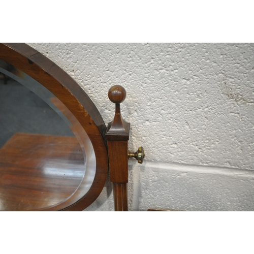 1244 - AN EARLY 20TH CENTURY MAHOGANY DRESSING TABLE, with an oval bevelled edge mirror, four drawers, rais... 