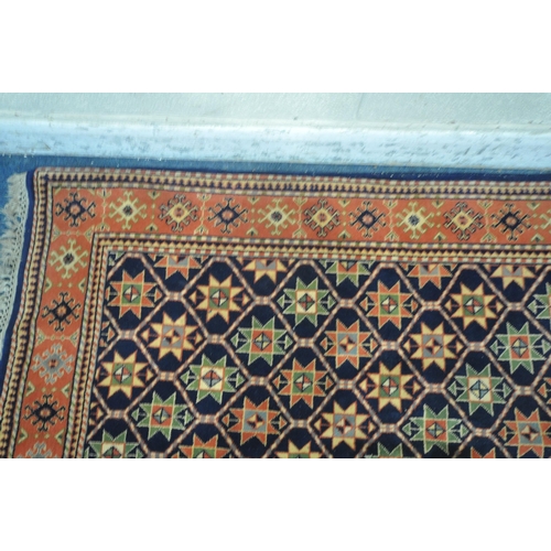 1261 - A WOOLEN RUG, with repeating geometric patterns, and a multi-strap border, 202cm x 122cm (condition ... 