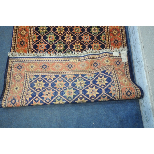 1261 - A WOOLEN RUG, with repeating geometric patterns, and a multi-strap border, 202cm x 122cm (condition ... 