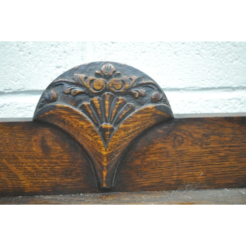 1268 - AN EARLY 20TH CENTURY OAK SIDEBOARD, fitted with three cupboard doors, the central and right hand do... 