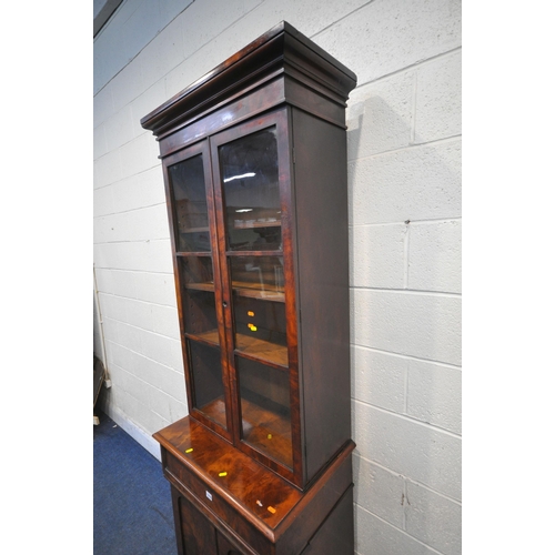 1276 - A SMIM 19TH CENTURY FLAME MAHOGANY BOOKCASE, fitted with double glazed doors, atop a base with a sin... 