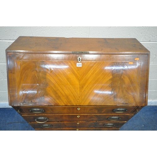 1277 - A GEORGIAN FLAME MAHOGANY BUREAU, the fall front door enclosing a fitted interior, above four long d... 