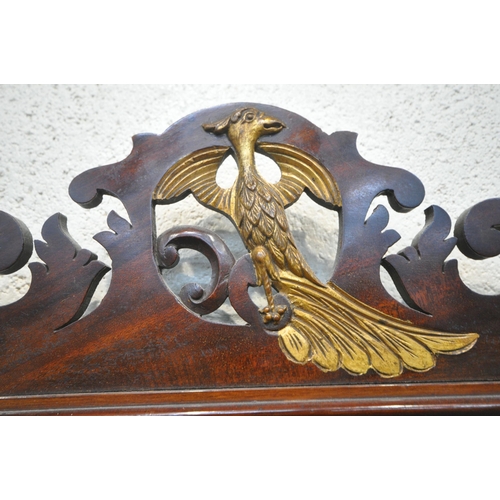 1280 - A 19TH CENTURY MAHOGANY FRETWORK BEVELLED EDGE WALL MIRROR, the crest depicting a majestic bird, the... 