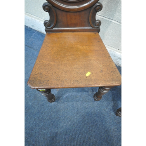 1288 - A PAIR OF VICTORIAN MAHOGANY HALL CHAIRS, with an oval back rest, raised on turned and tapered front... 