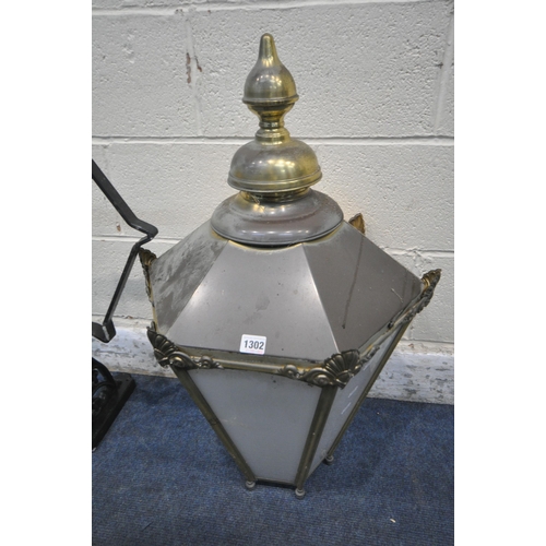 1302 - A BRASS HEXAGONAL TAPERED WALL HANGING LANTERN, with a finial and metal bracket, height approximatel... 