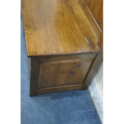 1305 - TERRY 'RAM MAN' HARRINGTON, A SOLID OAK HALL SETTLE, with a hinged seat, width 106cm x depth 48cm x ... 