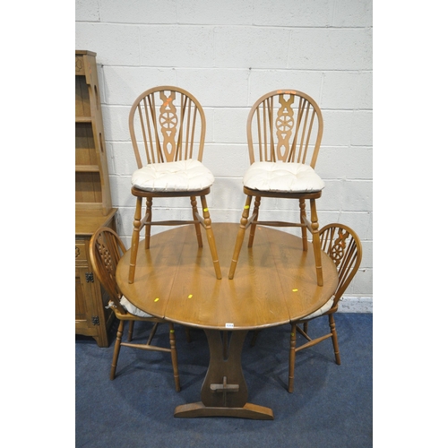 1314 - A LATE 20TH CENTURY OAK DROP LEAF DINING TABLE, raised on trestle legs, diameter 121cm x closed widt... 