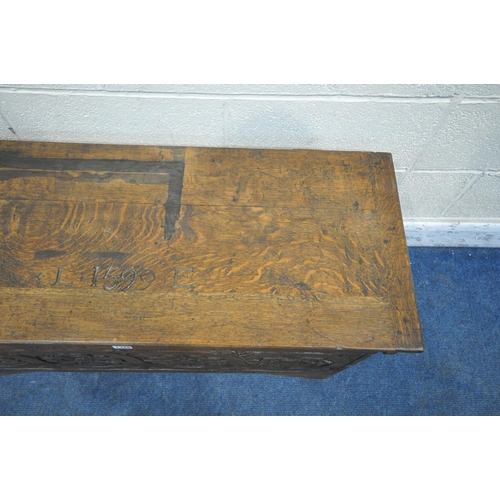 1326 - AN EARLY 20TH CENTURY BOARDED CHEST, the hinged lid carved with 'L 1599 E' the front panel with carv... 