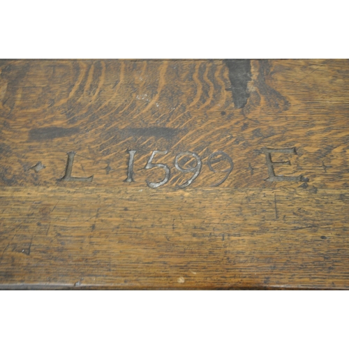 1326 - AN EARLY 20TH CENTURY BOARDED CHEST, the hinged lid carved with 'L 1599 E' the front panel with carv... 