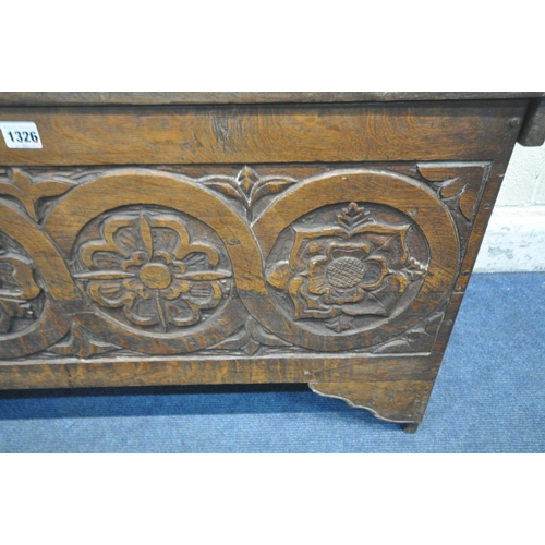 1326 - AN EARLY 20TH CENTURY BOARDED CHEST, the hinged lid carved with 'L 1599 E' the front panel with carv... 