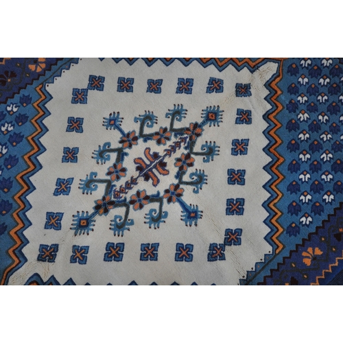 1344 - A BLUE AND CREAM TUNISIAN RECTANGULAR WOOLEN RUG, with repeating patterns, 203cm x 146cm (condition ... 