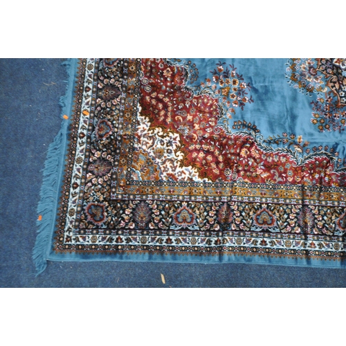 1345 - A LARGE RECTANGULAR BLUE AND RED WOOLEN TUNISIAN RUG, with repeating patterns and multi-strap border... 