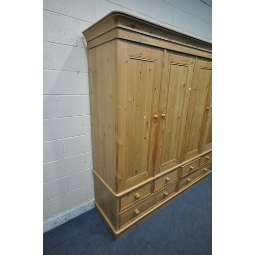 1347 - A LARGE MODERN PINE FOUR DOOR WARDROBE, with six assorted drawers, width 217cm x depth 61cm x height... 