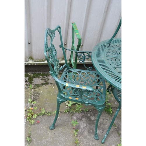 1008 - A CAST ALUMINIUM GARDEN TABLE  79cm in diameter, three similar chairs and a cast iron sewing machine... 