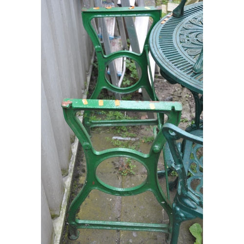 1008 - A CAST ALUMINIUM GARDEN TABLE  79cm in diameter, three similar chairs and a cast iron sewing machine... 