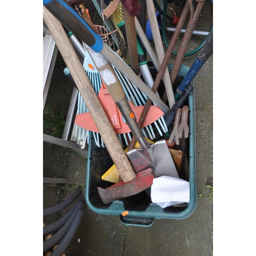 1017 - A COLLECTION OF GARDENING ITEMS including two potting tables, a hose reel, step ladders, forks, spad... 