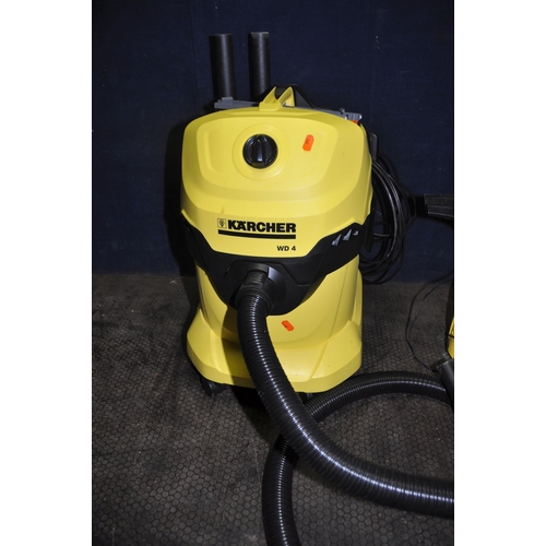 1061 - A KARCHER WD4 CARPET CLEANER with one floor head and brush attachment along with a Karcher window va... 