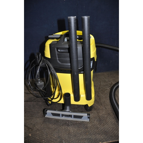 1061 - A KARCHER WD4 CARPET CLEANER with one floor head and brush attachment along with a Karcher window va... 