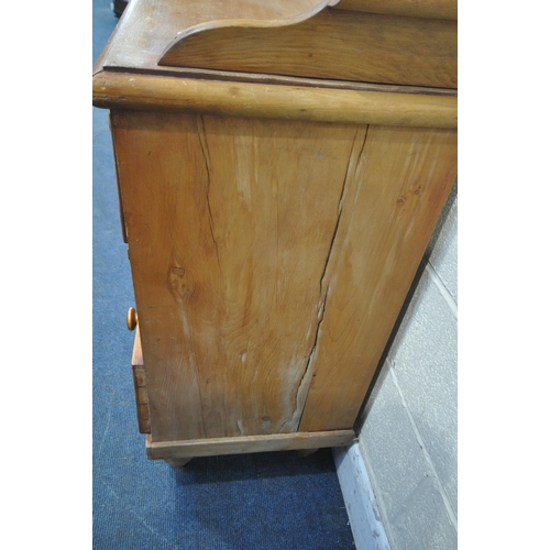 1206 - A VICTORIAN PINE WASHSTAND, with raised back and sides, fitted with two short over two long drawers,... 