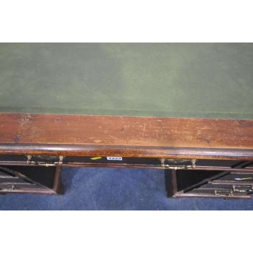 1223 - A 20TH CENTURY MAHOGANY TWIN PEDESTAL DESK, with a green leather writing surface, fitted with eight ... 