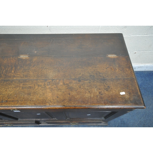 1226 - A GEORGIAN OAK COFFER, with a hinged lid, three front panels, and two drawers, width 136cm x depth 5... 