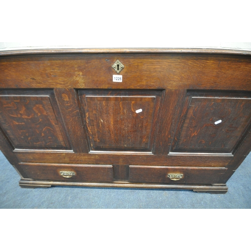 1226 - A GEORGIAN OAK COFFER, with a hinged lid, three front panels, and two drawers, width 136cm x depth 5... 