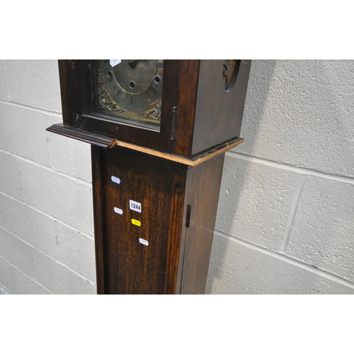 1244 - A 20TH CENTURY OAK GRANDDAUGHTER CLOCK, the arched door enclosing a brass dial, height 170cm (condit... 