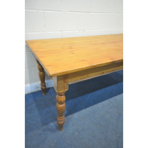 1248 - A 19TH CENURY PINE RECTANGULAR TABLE, raised on turned legs, length 213cm x depth 84cm x height 77cm... 