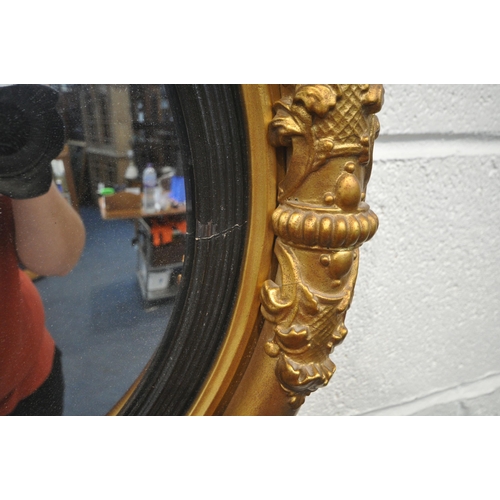 1257 - A REGENCY STYLE CICRULAR CONVEX WALL MIRROR, the frame with carved details (condition report: some s... 